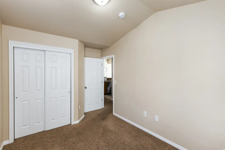 Neutral-toned walls complement the brown carpeting