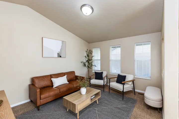 Vaulted ceilings enhance the living area, complemented by multiple windows providing natural light