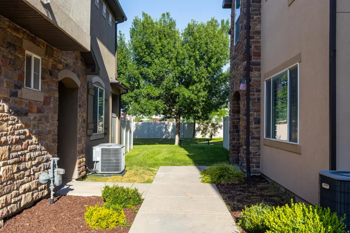 Manicured lawn with mature trees and concrete pathway