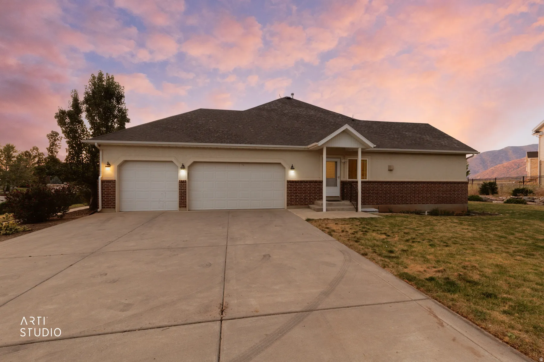 Single-story residence featuring a two-car garage, concrete driveway, and a covered entry