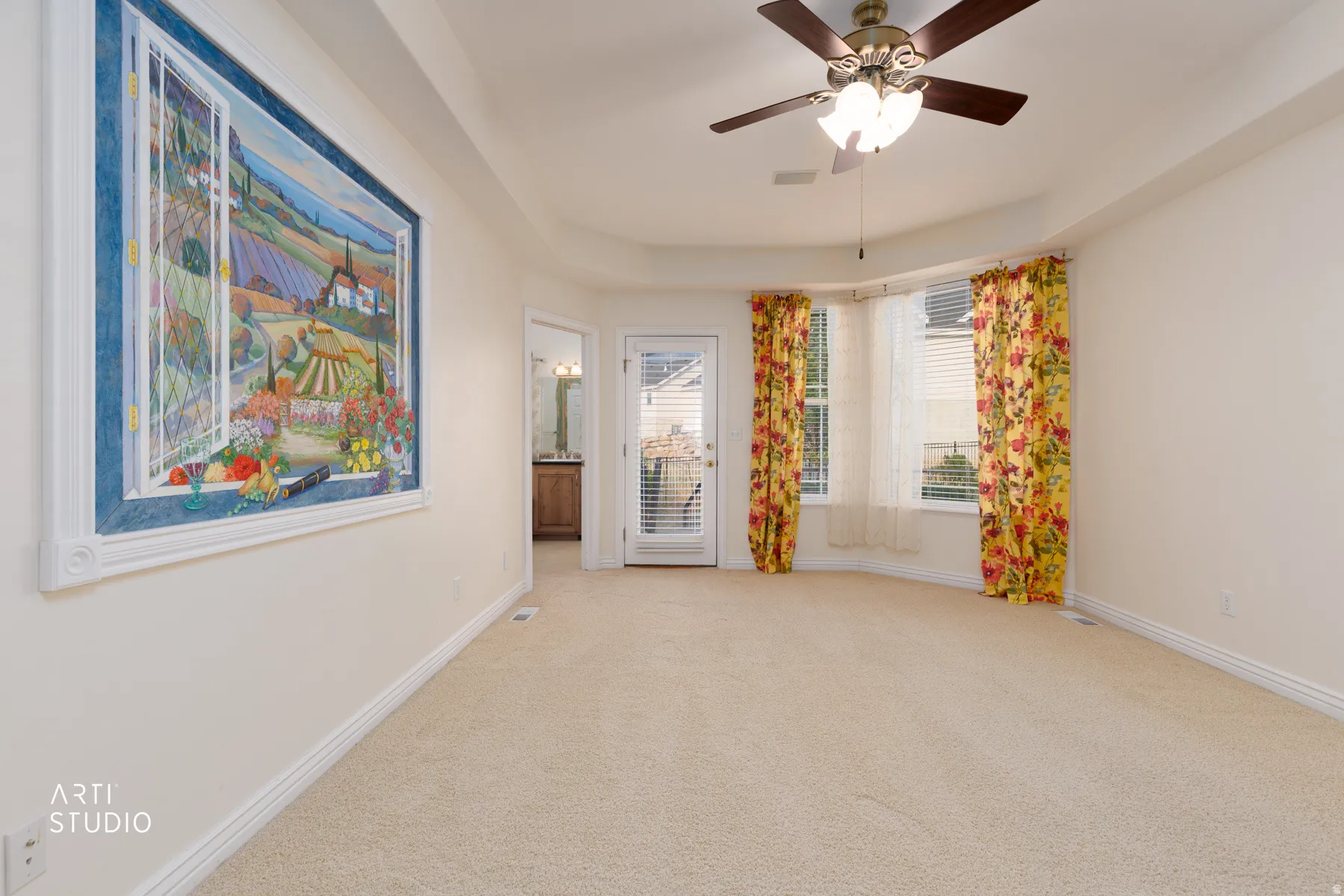 Spacious master bedroom featuring neutral carpet flooring and a neutral painted wall