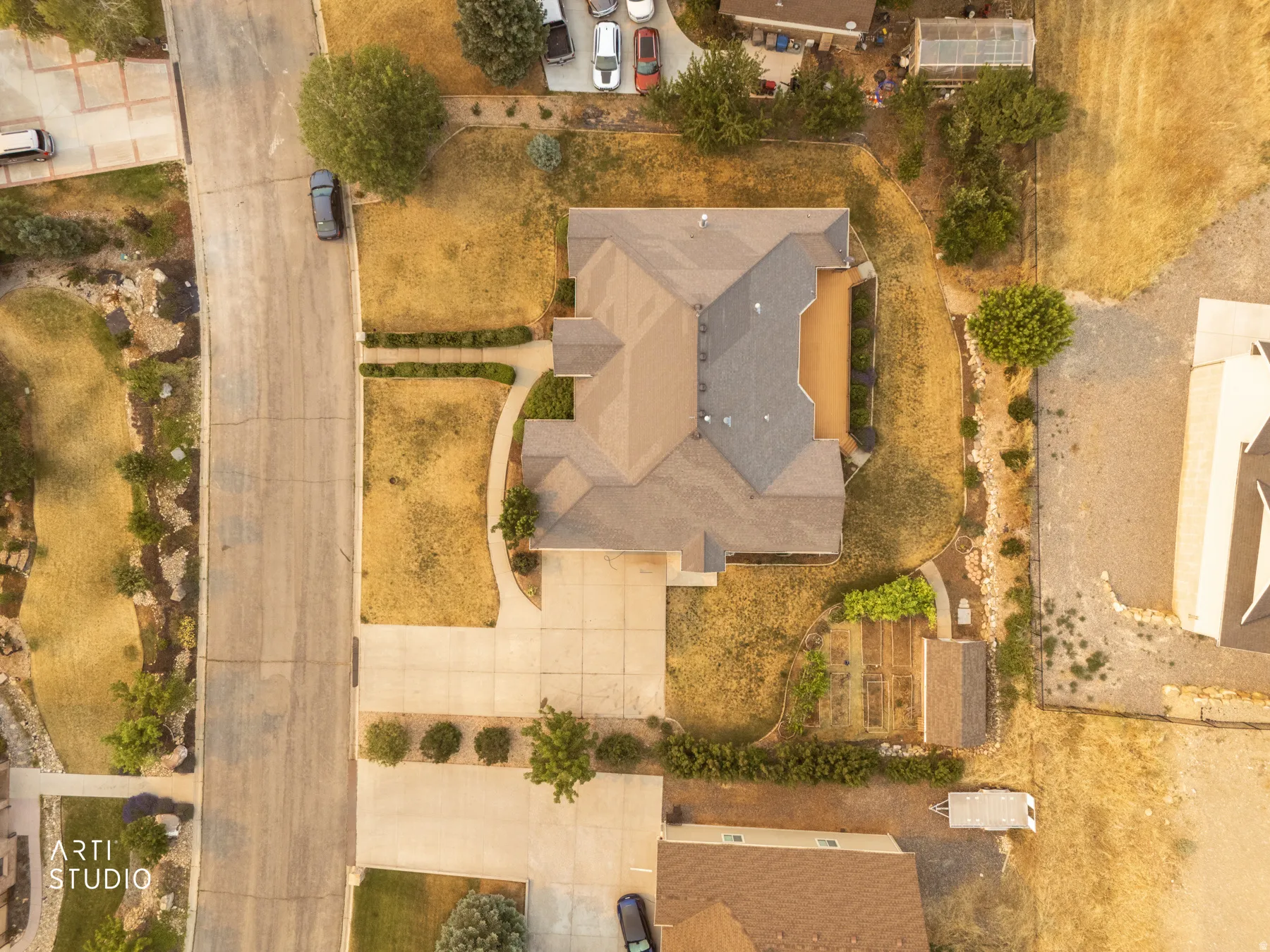 Single-family residence featuring a multi-gabled roofline, concrete driveway, and established landscaping