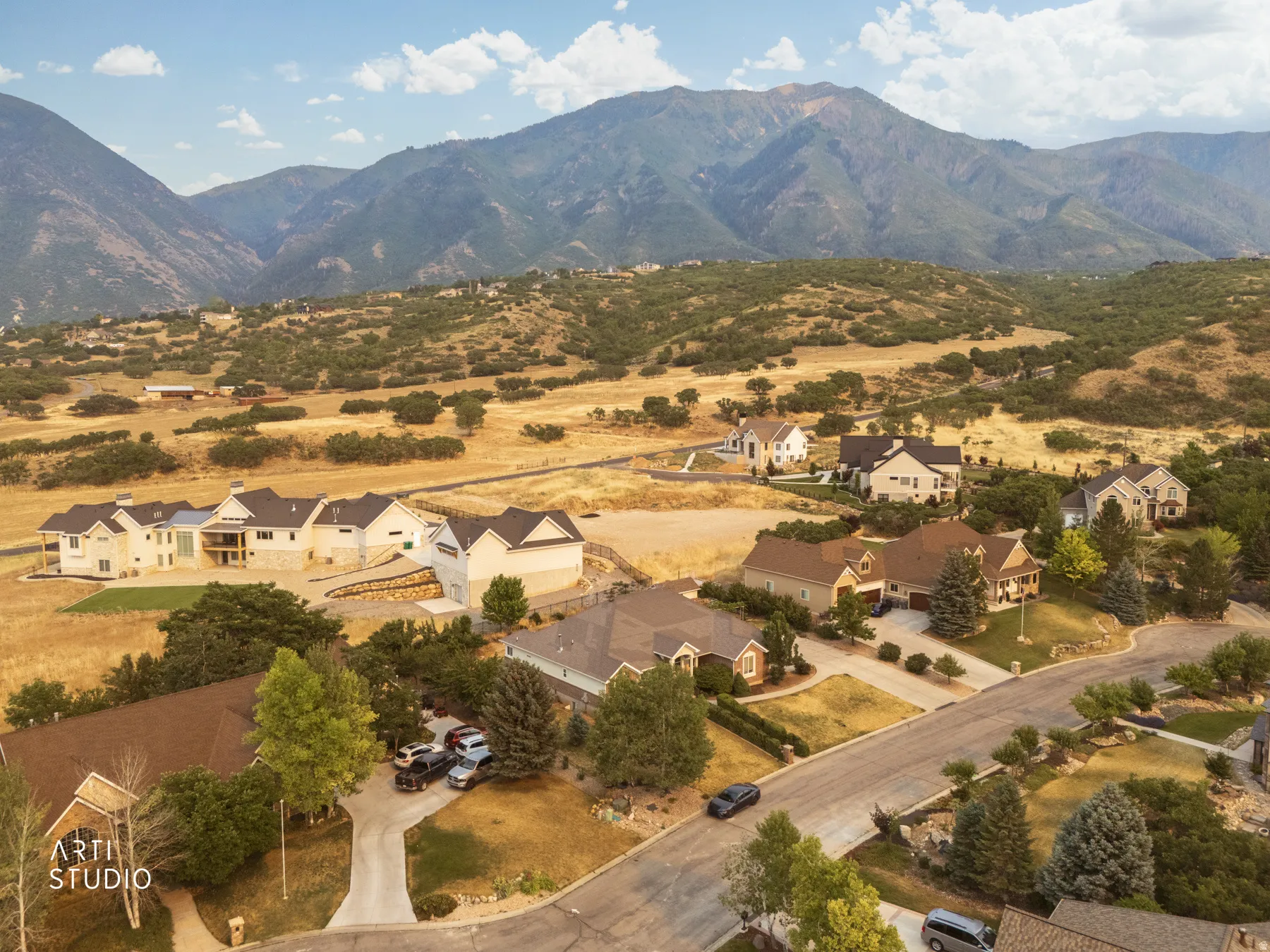 Expansive residential community featuring a variety of architectural styles, surrounded by natural terrain and foothills