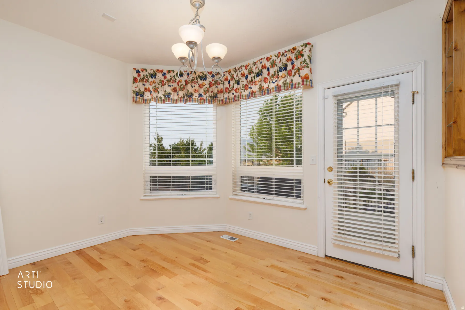 Bright interior space featuring light wood-finish flooring