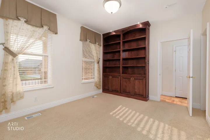 Built-in wood-finish shelving with recessed lighting and lower cabinetry