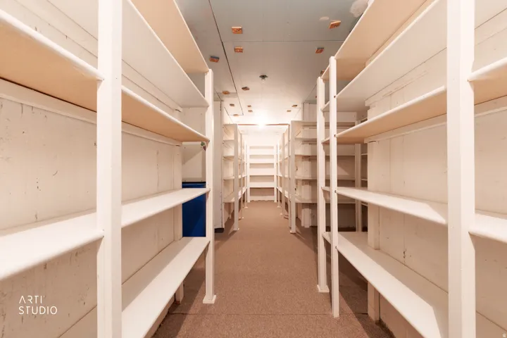 Extensive storage room with multiple rows of built-in shelving, providing abundant organizational capacity