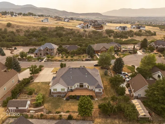 Expansive property featuring a multi-level deck, detached shed, and a greenhouse structure