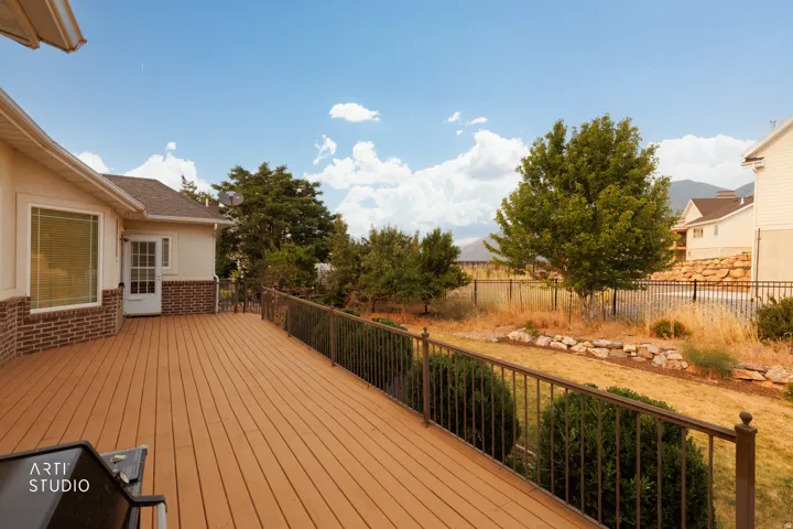 Spacious deck with composite decking and dark metal railings