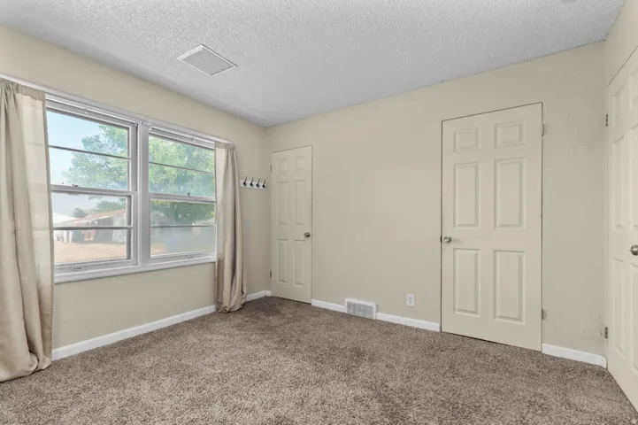 Light-colored walls complementing soft gray carpeting