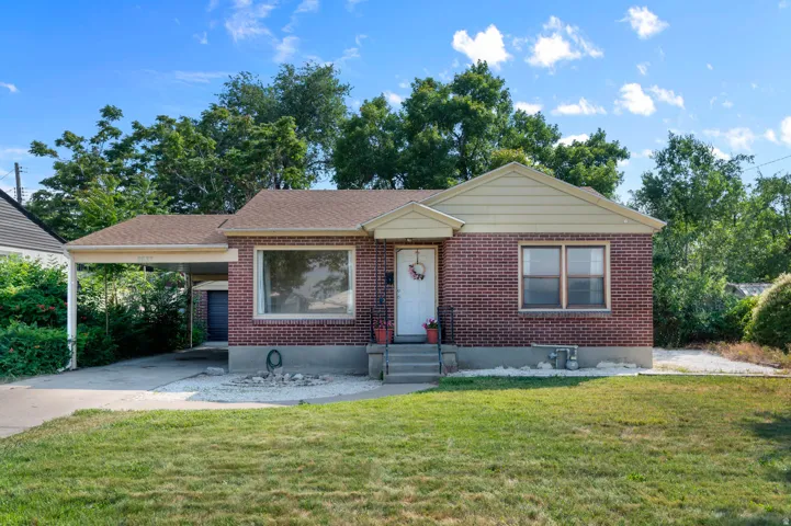 Brick exterior with a covered carport