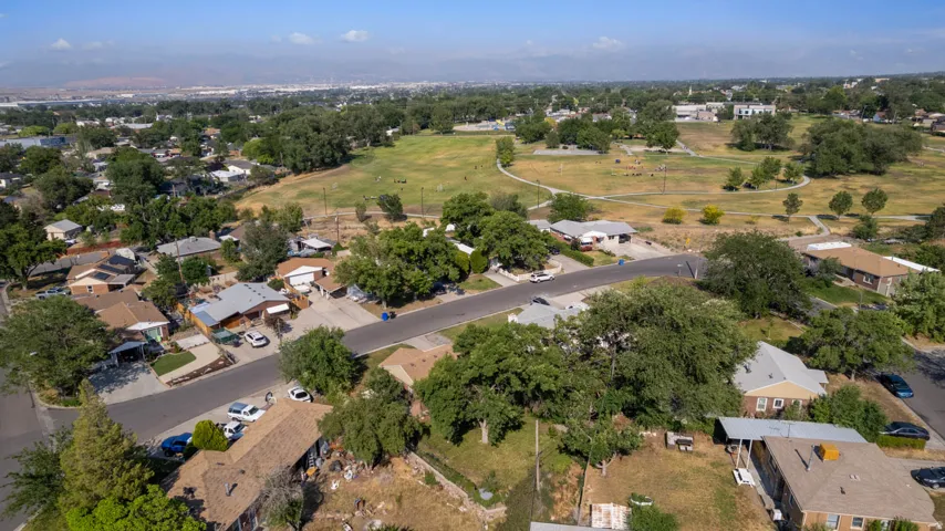 Aerial perspective showcasing a residential neighborhood with a large, open park area