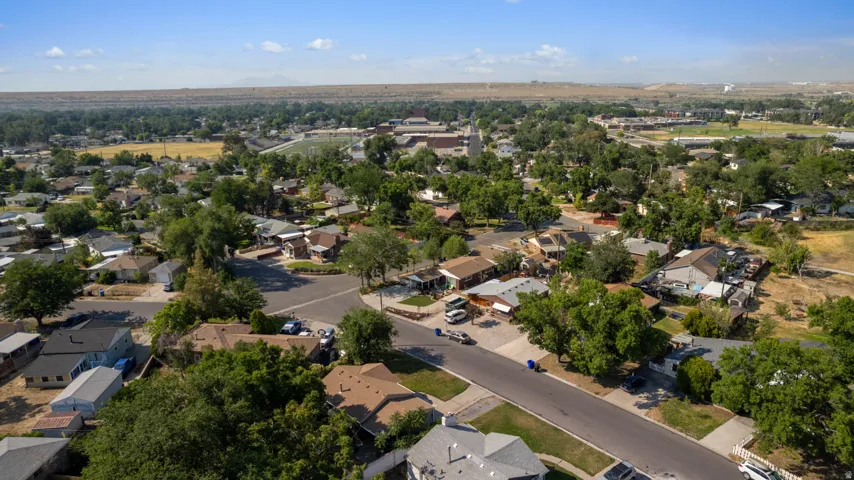 Aerial perspective showcasing a residential neighborhood with mature trees, established streets, and varied single-family homes