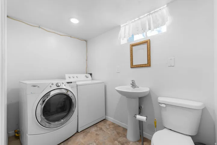 Laundry area with front-loading washer and top-loading dryer