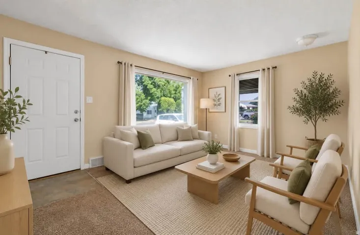 Living area featuring carpet flooring, dual windows with curtain rods, and a white paneled entry door