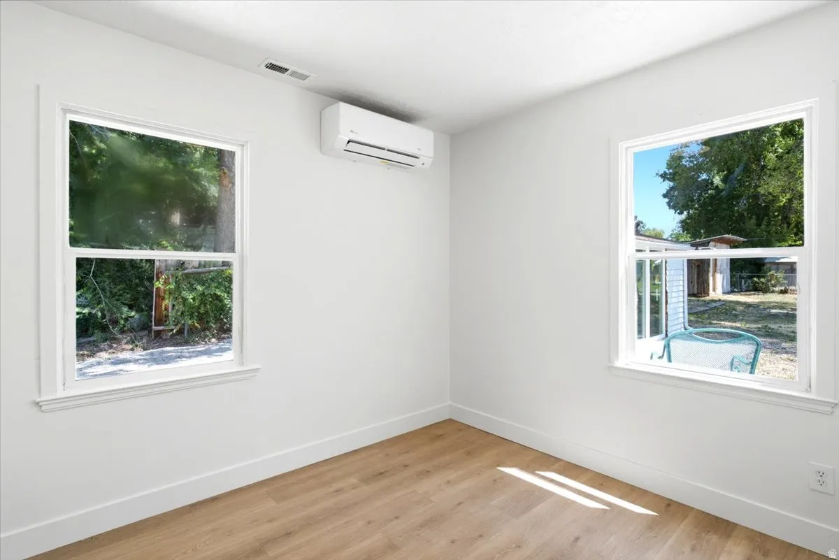 Bright interior space featuring light wood-finish flooring and white painted walls
