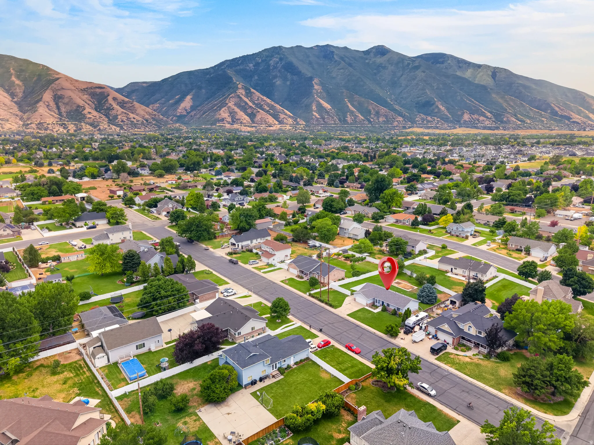 Aerial perspective showcasing a residential neighborhood with distant mountains