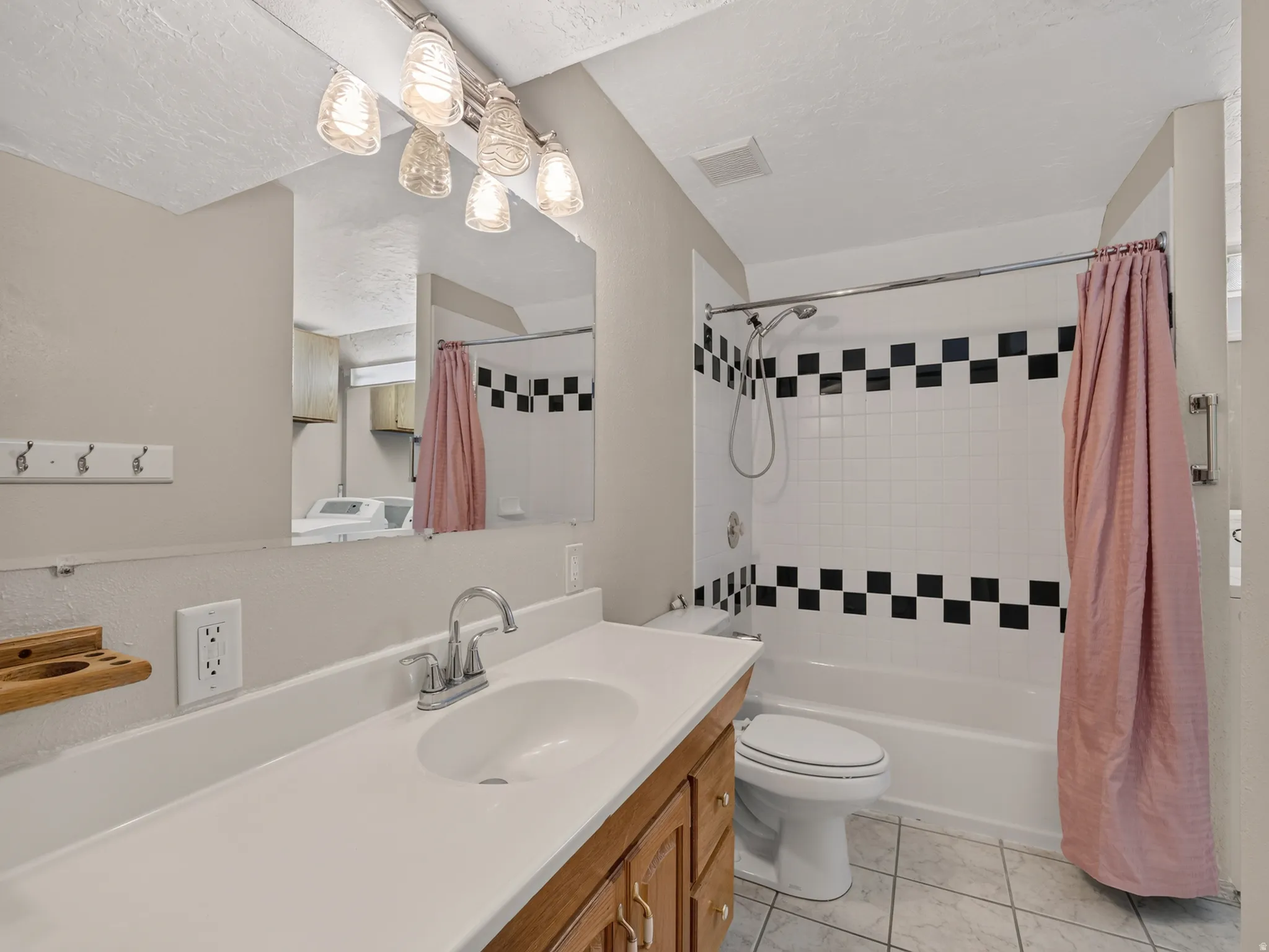 Bathroom featuring a single vanity with a white countertop and wood cabinetry
