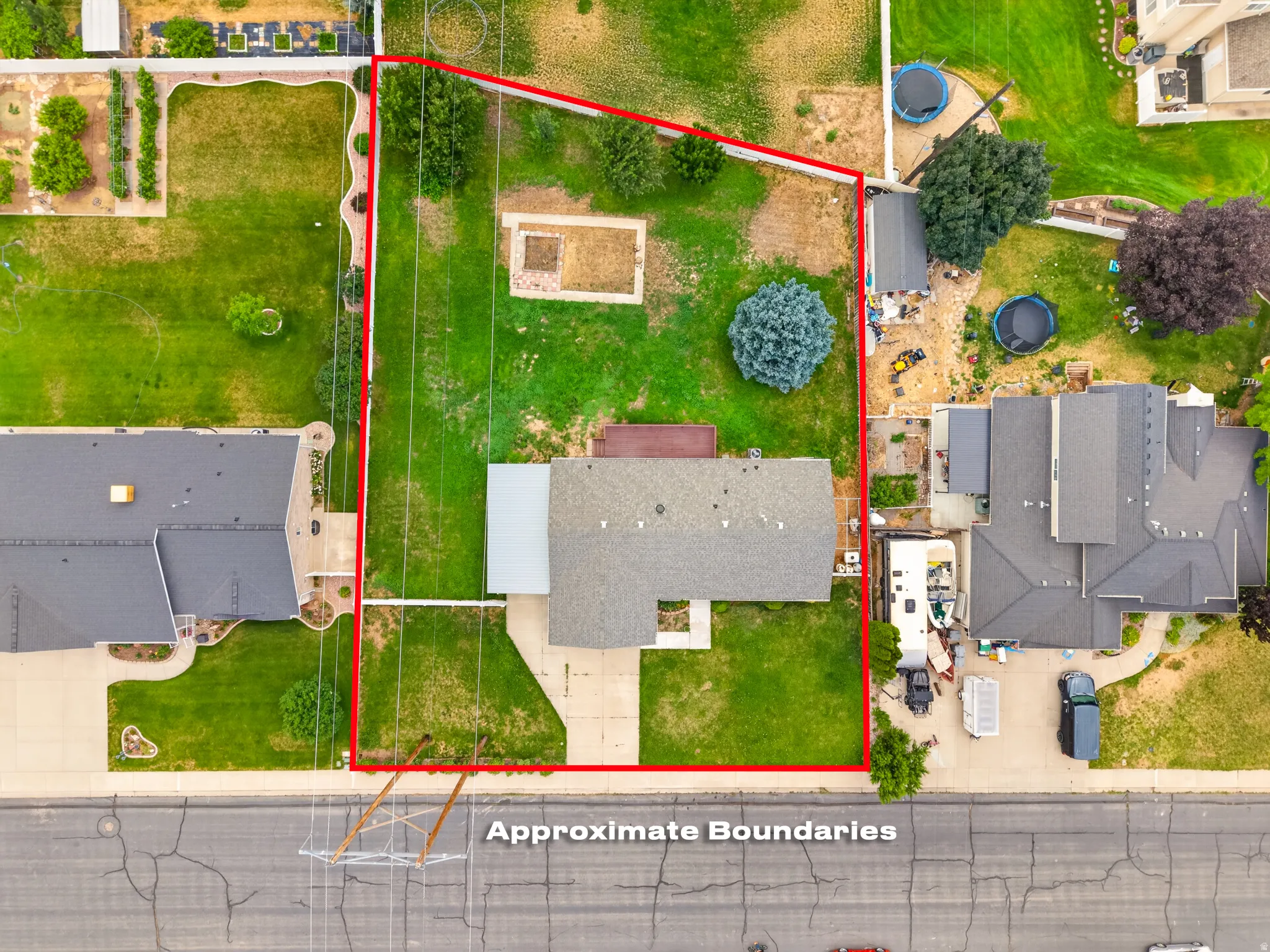 Expansive property featuring a large grass lawn, mature trees, and an extended driveway