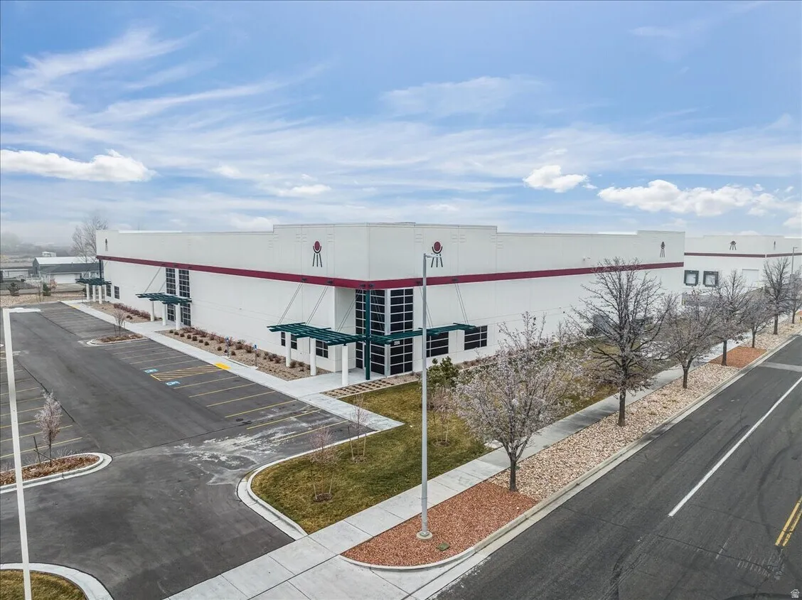 Commercial building with white facade and red trim accents