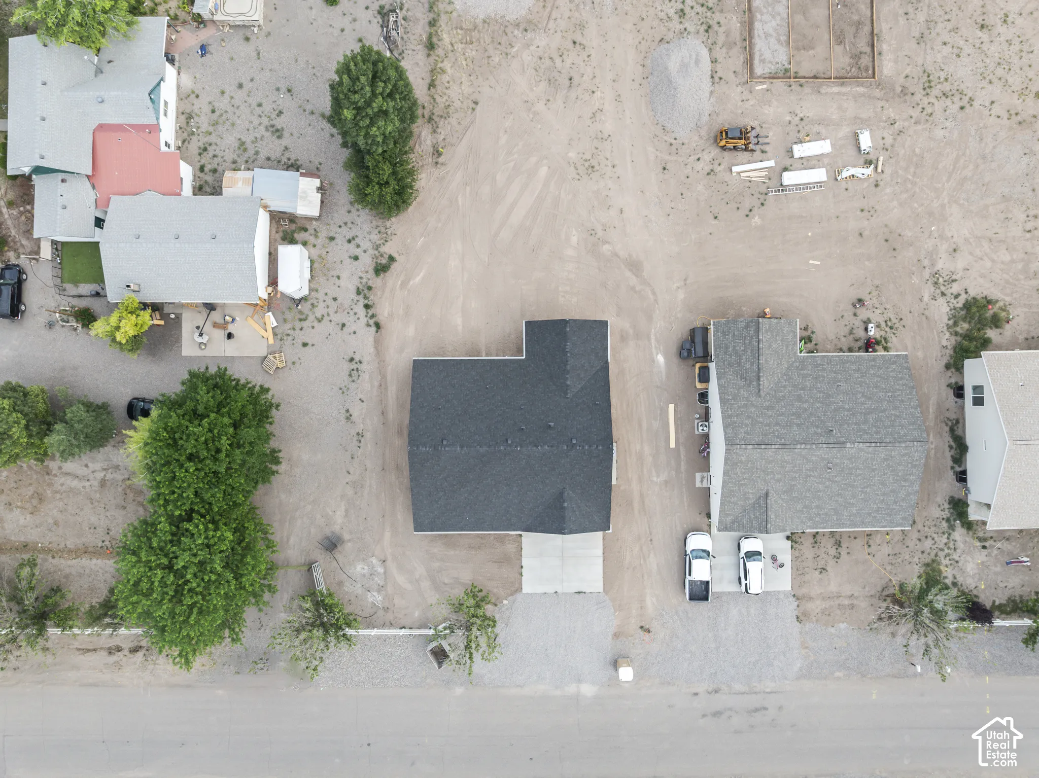 New construction home featuring a dark shingle roof and a concrete driveway