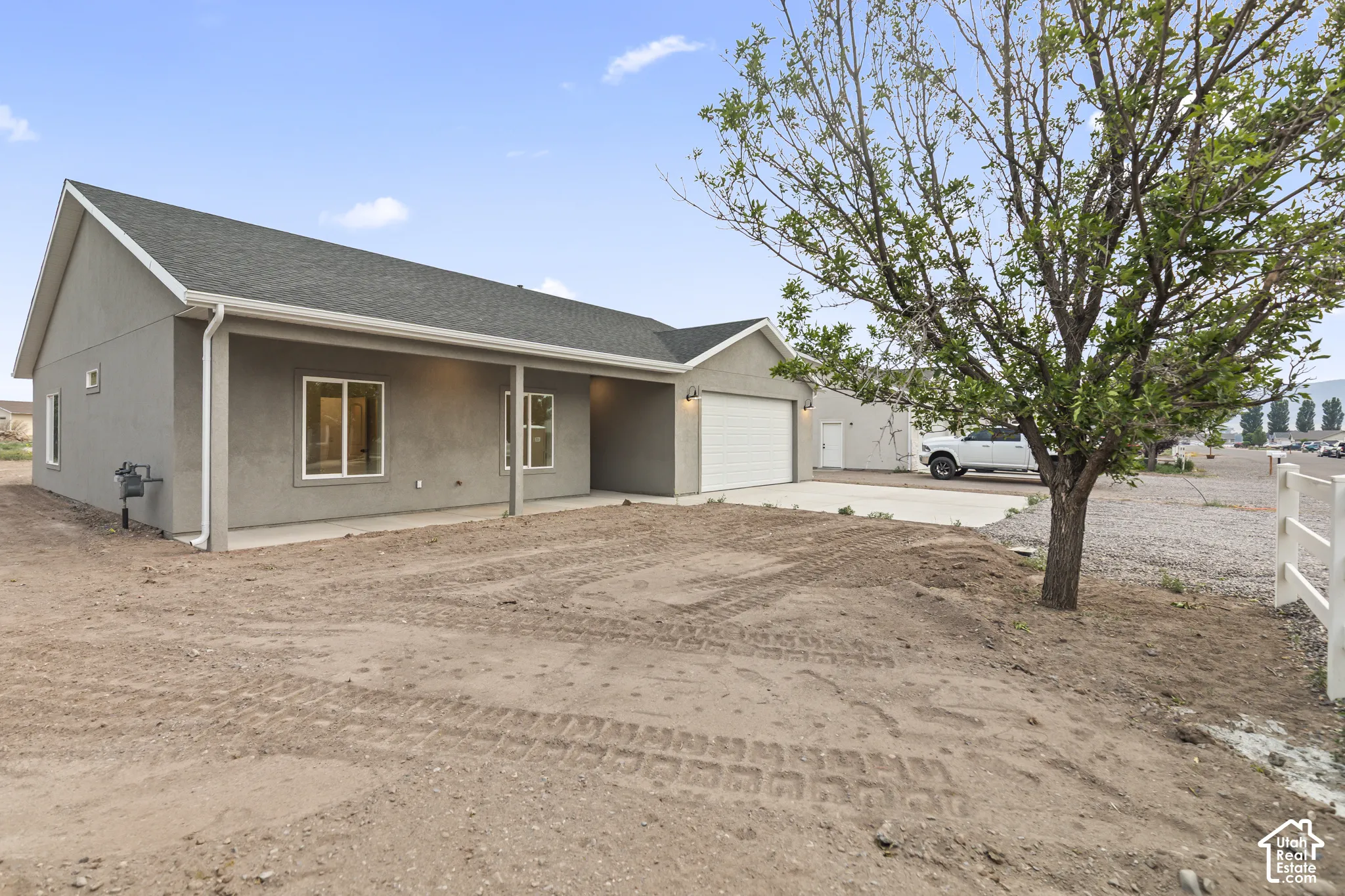 Contemporary single-story residence featuring a stucco exterior and an attached garage with a white overhead door