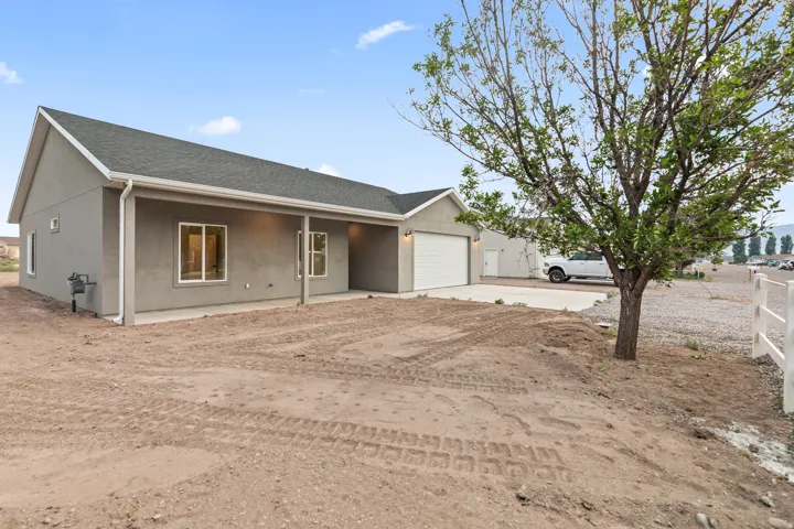 Contemporary single-story residence featuring a stucco exterior and an attached garage with a white overhead door