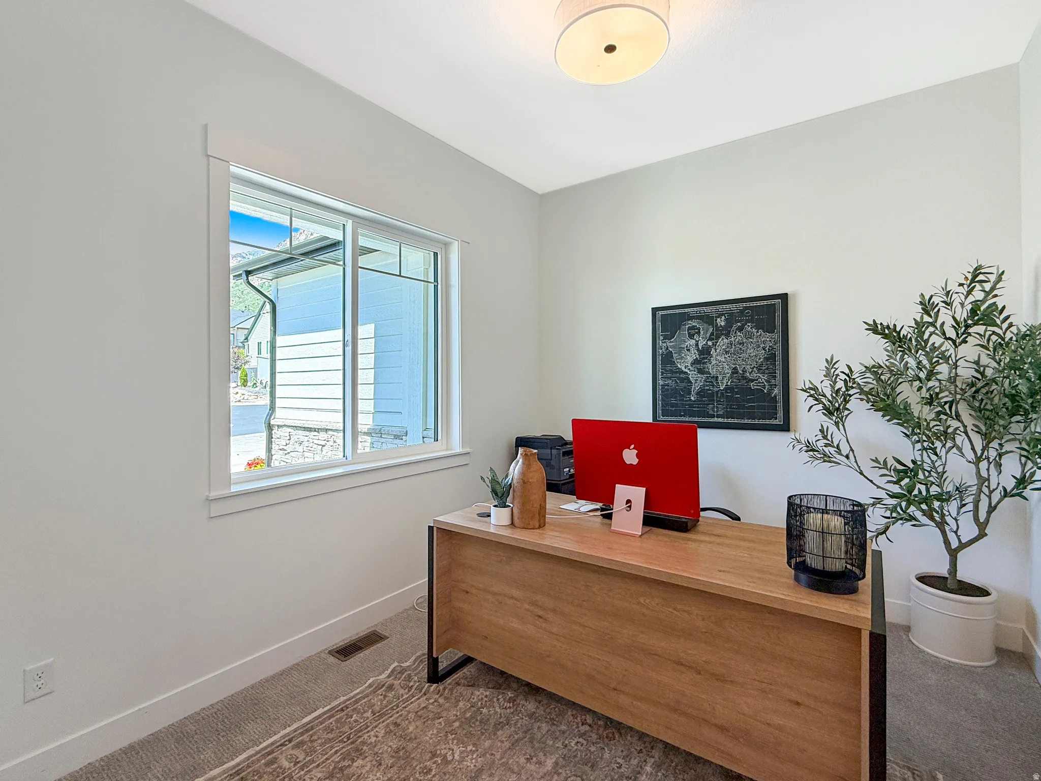 Bright office with a large window and light-toned walls