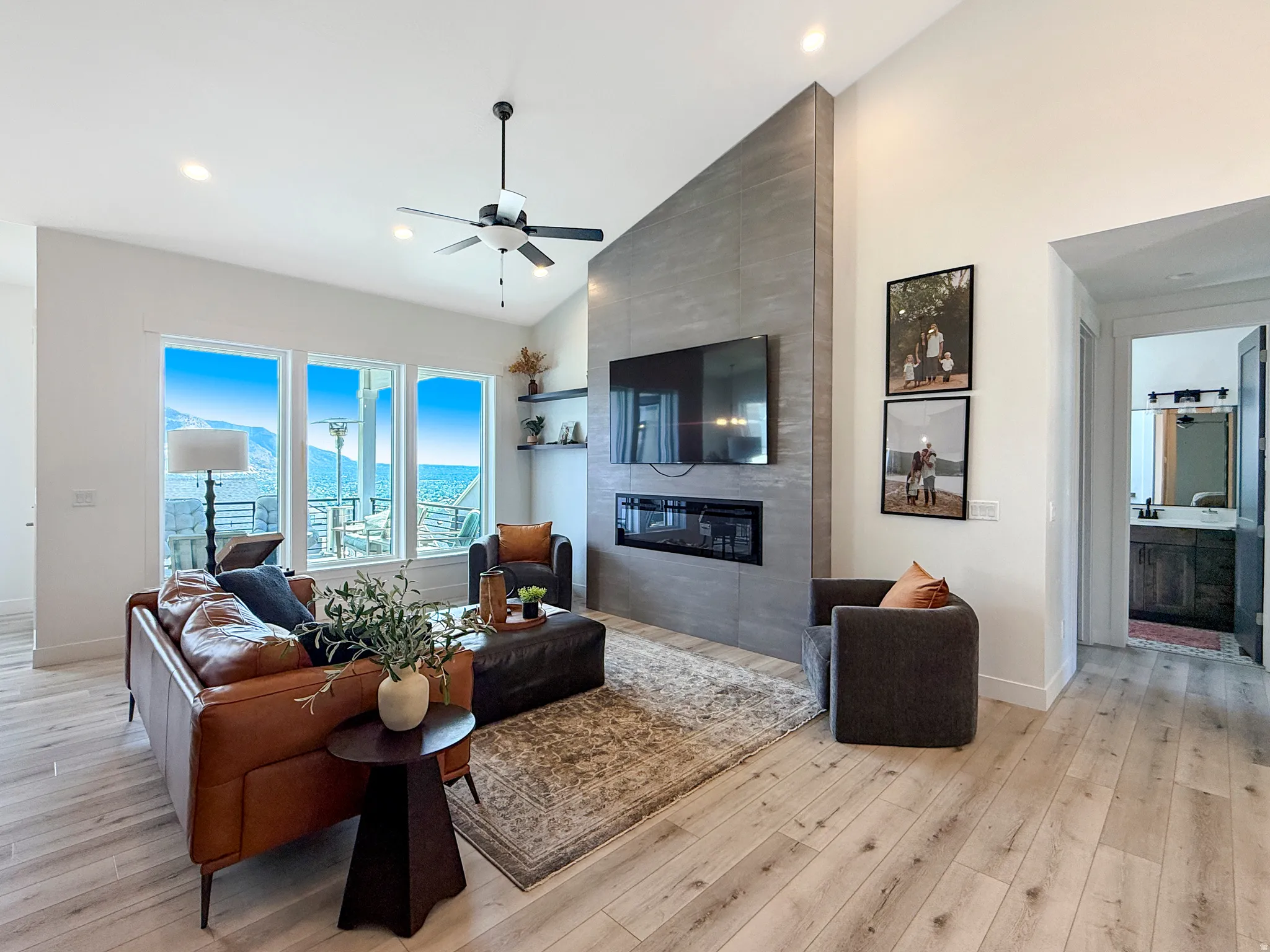 Spacious living area featuring a vaulted ceiling and light wood-finish flooring