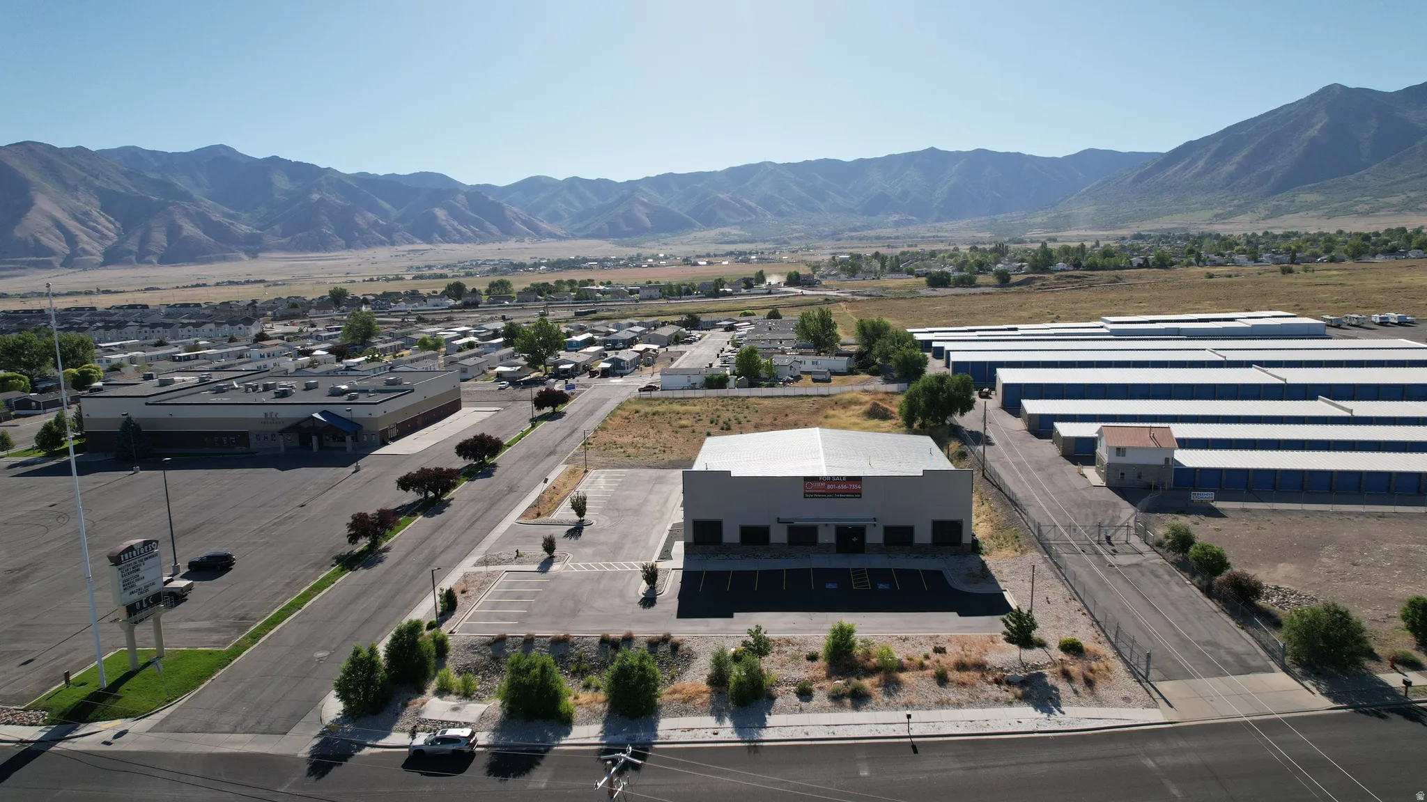 Commercial building featuring a flat roof and multiple garage bay doors
