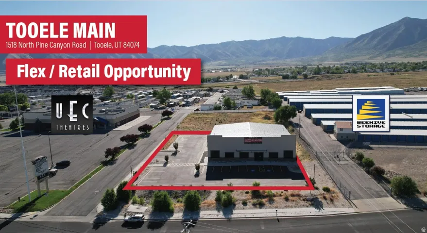 Commercial building with a prominent parking lot, situated on a paved road