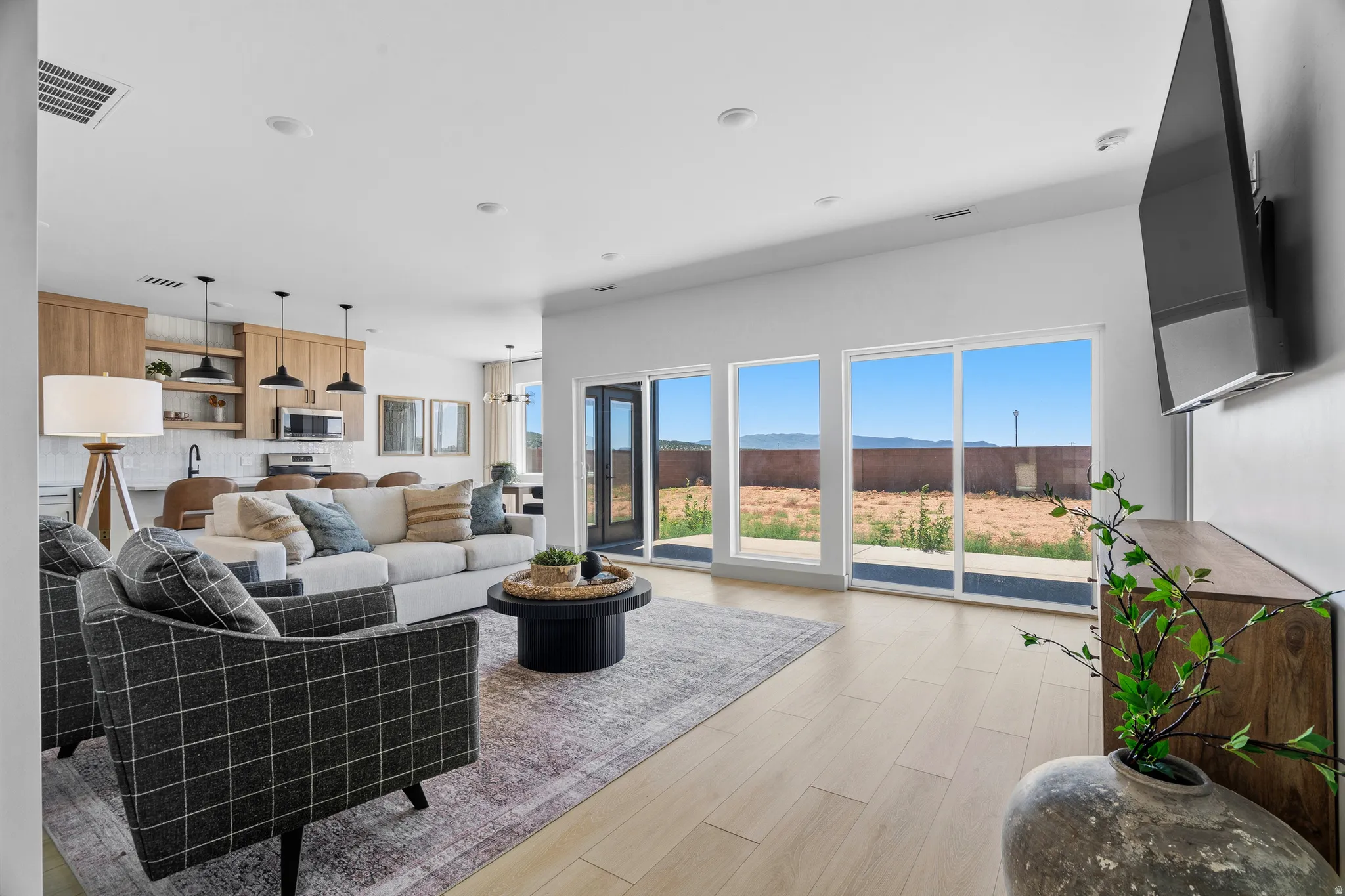Light wood-finish flooring extending throughout the open concept living space