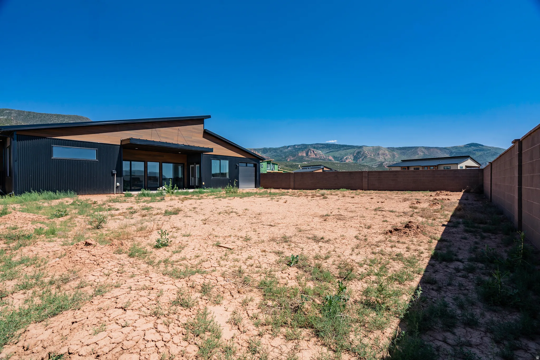 Modern-style exterior featuring corrugated metal siding and a sloped roofline