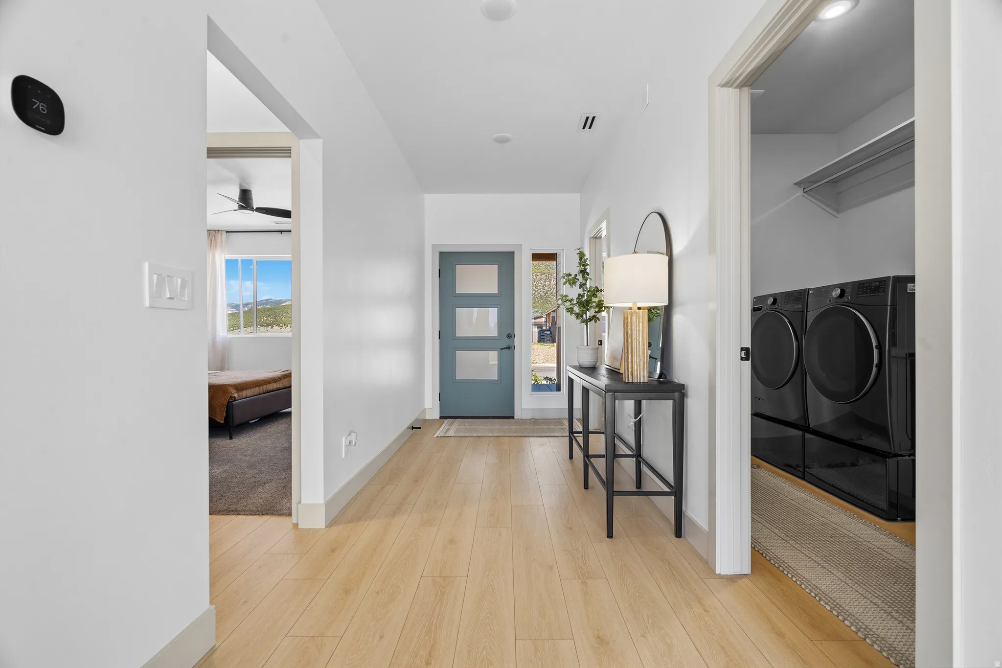 Light wood-finish flooring extending through the entry hall