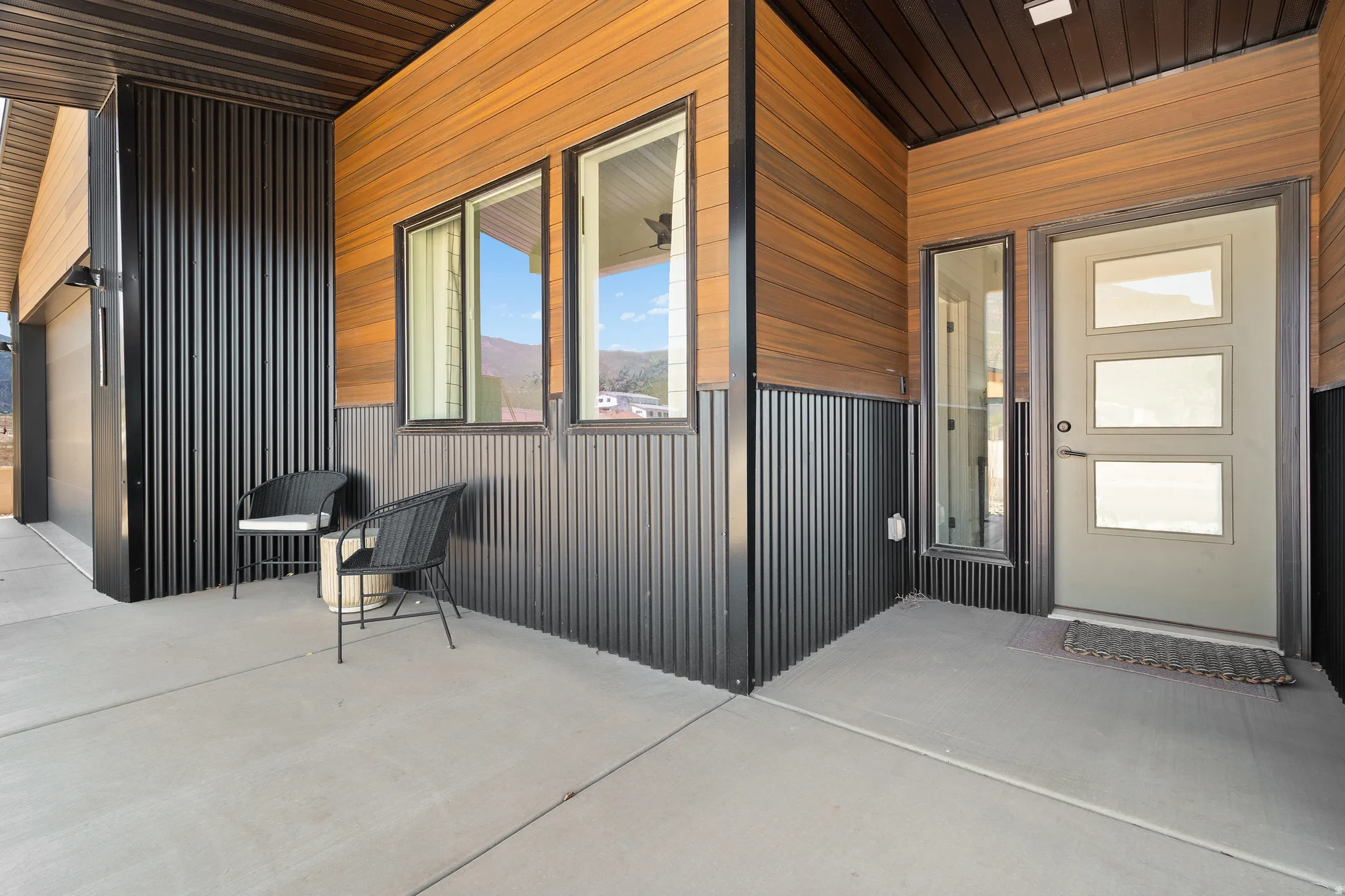 Contemporary exterior featuring wood-finish siding and dark vertical paneling