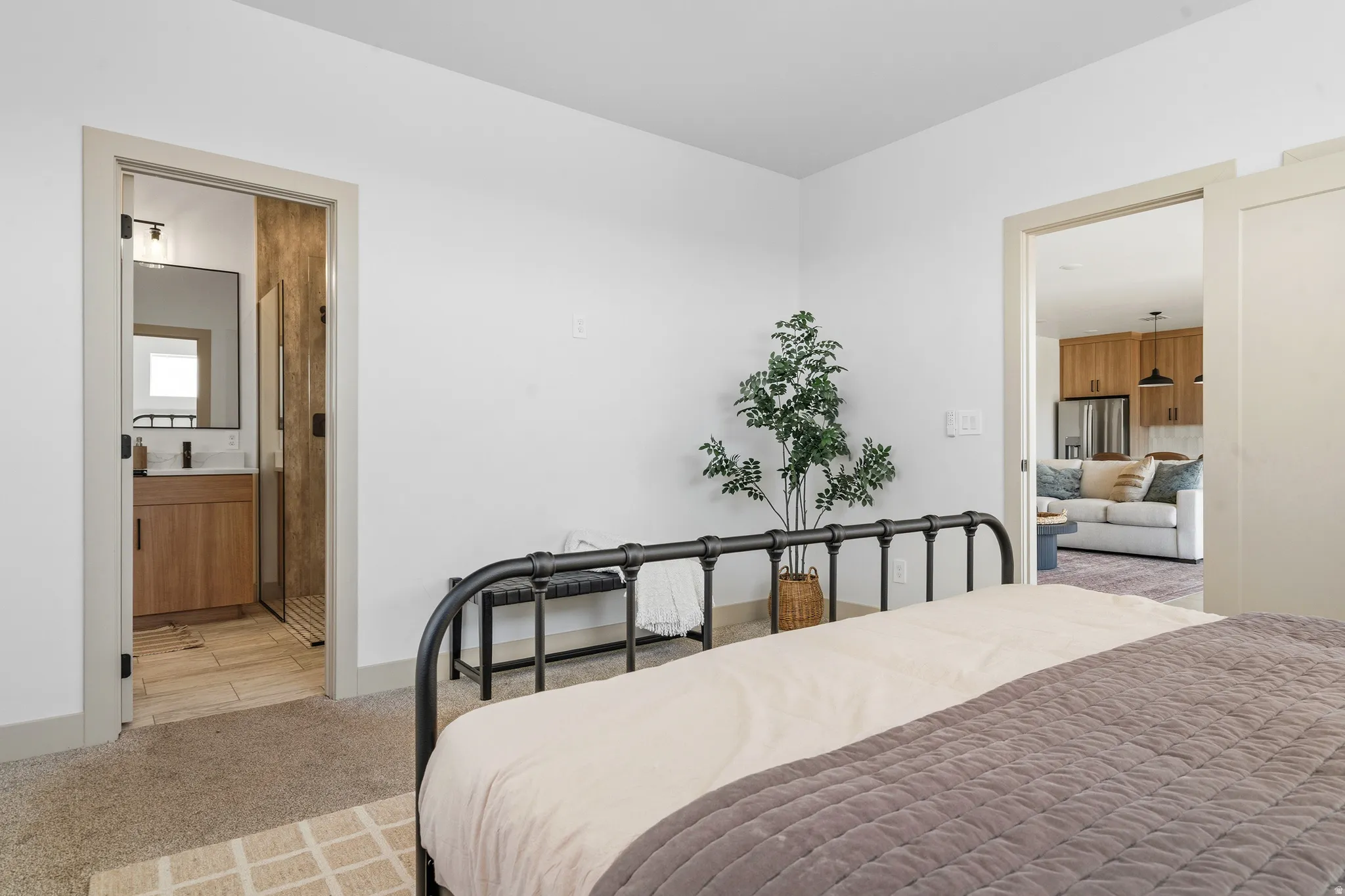 Bedroom featuring a neutral carpet, white walls, and a recessed doorway
