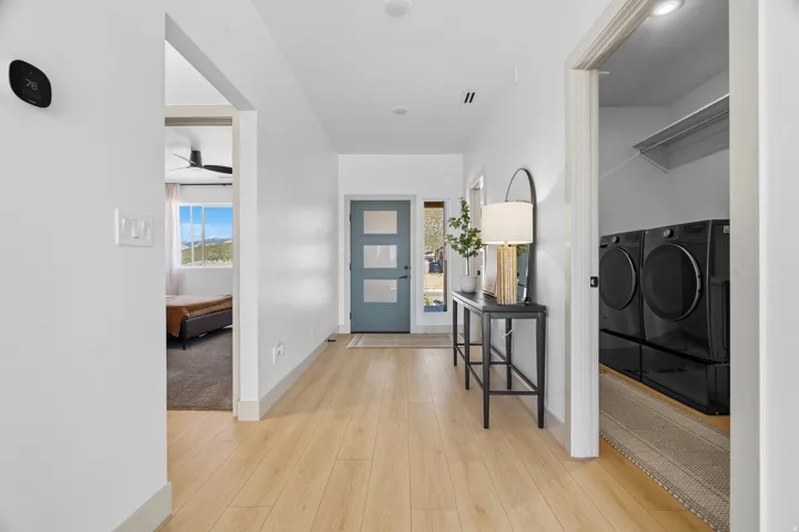 Light wood-finish flooring extending through the entry hall