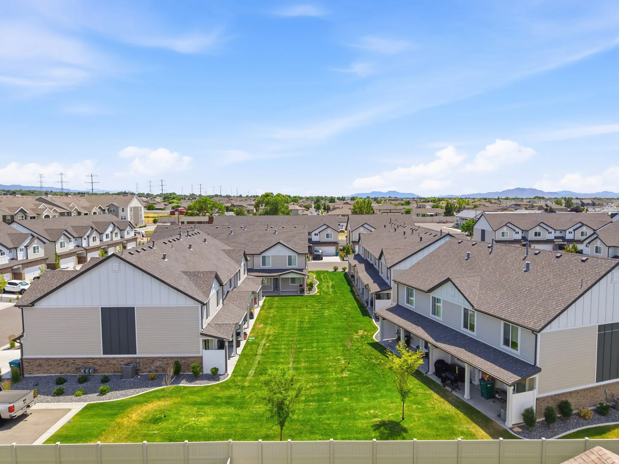 Expansive green space bordered by contemporary townhome-style residences