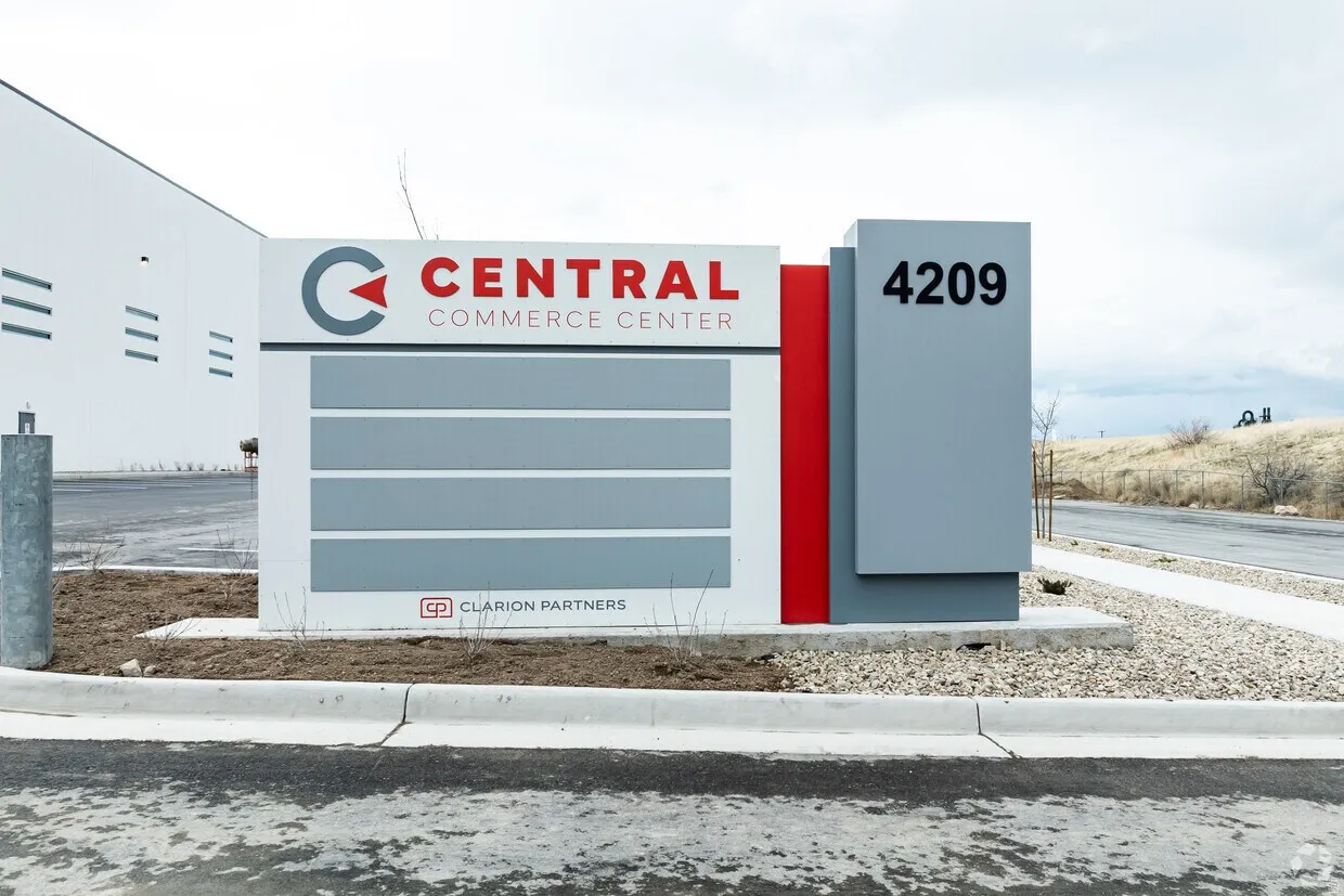 Modern monument sign featuring "Central Commerce Center" branding with a distinct 4209 address panel