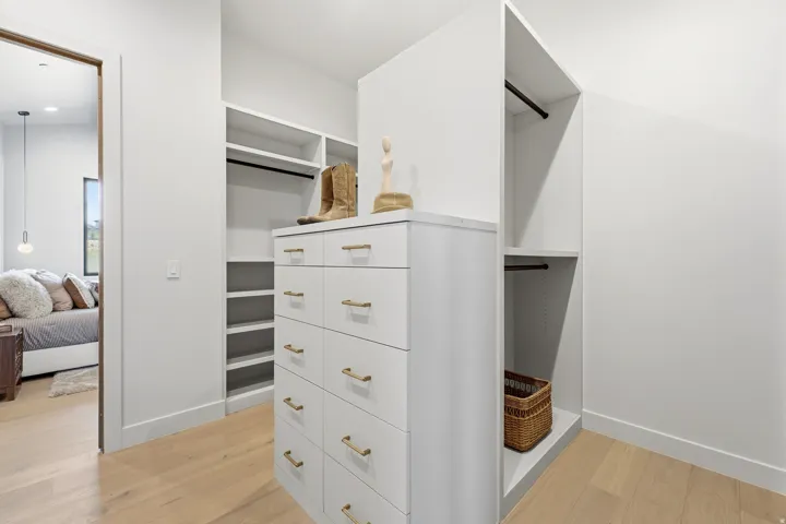 Built-in closet system with shelving and hanging rods
