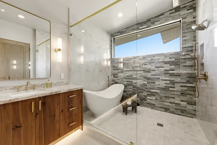 Floating wood vanity with integrated lighting and a rectangular undermount sink