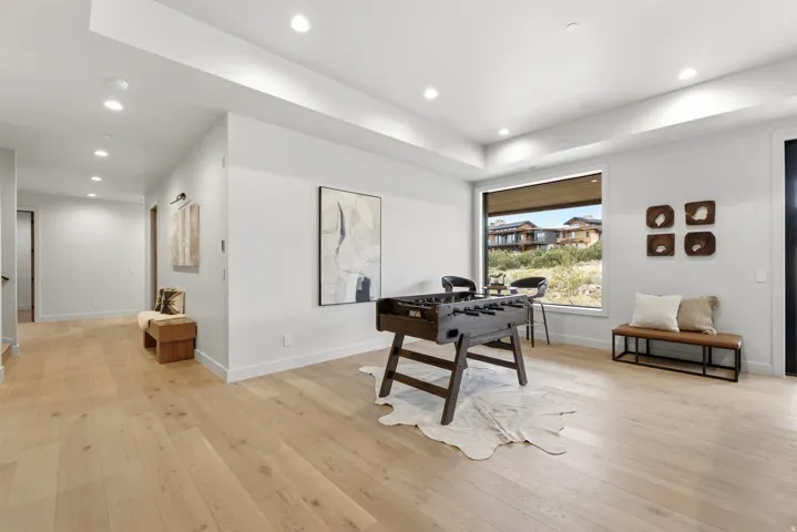 Recessed lighting, wood-finish flooring, a large picture window, and a built-in bench