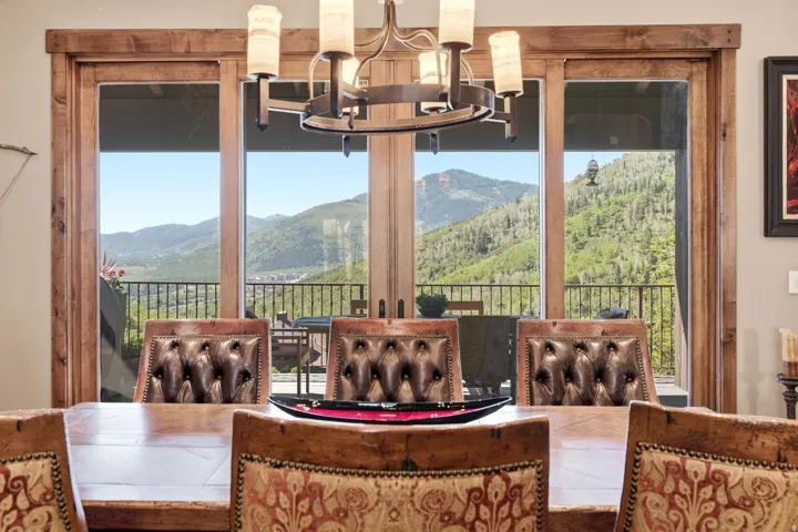 Expansive patio doors with natural wood trim offering a mountain backdrop