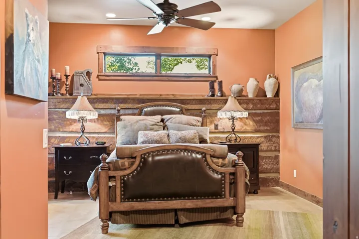 Bedroom with exposed log wall detailing and a wooden window frame