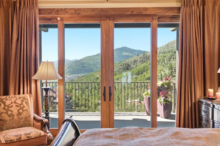 Expansive mountain scenery visible through full-light patio doors