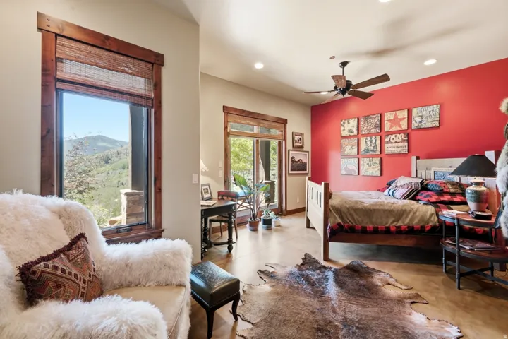 Spacious interior featuring a large picture window with natural wood trim, a sliding glass door, recessed lighting, and a ceiling fan