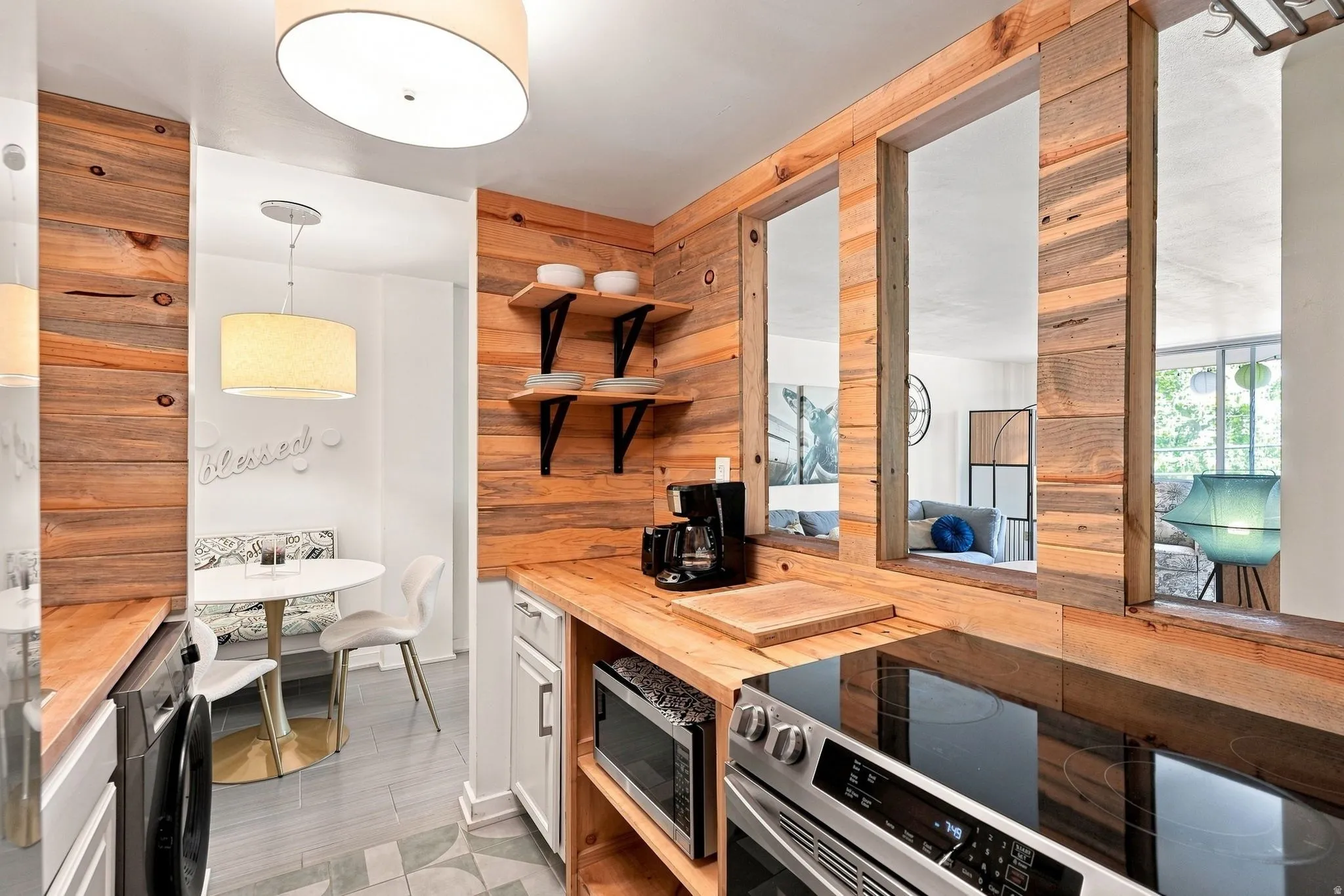 Kitchen featuring wood-finish walls, open shelving, and a built-in oven with a smooth cooktop