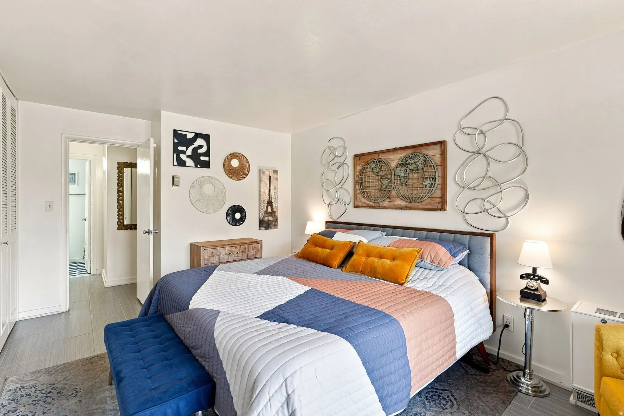 White walls, wood-finish flooring, louvered closet doors, and recessed lighting
