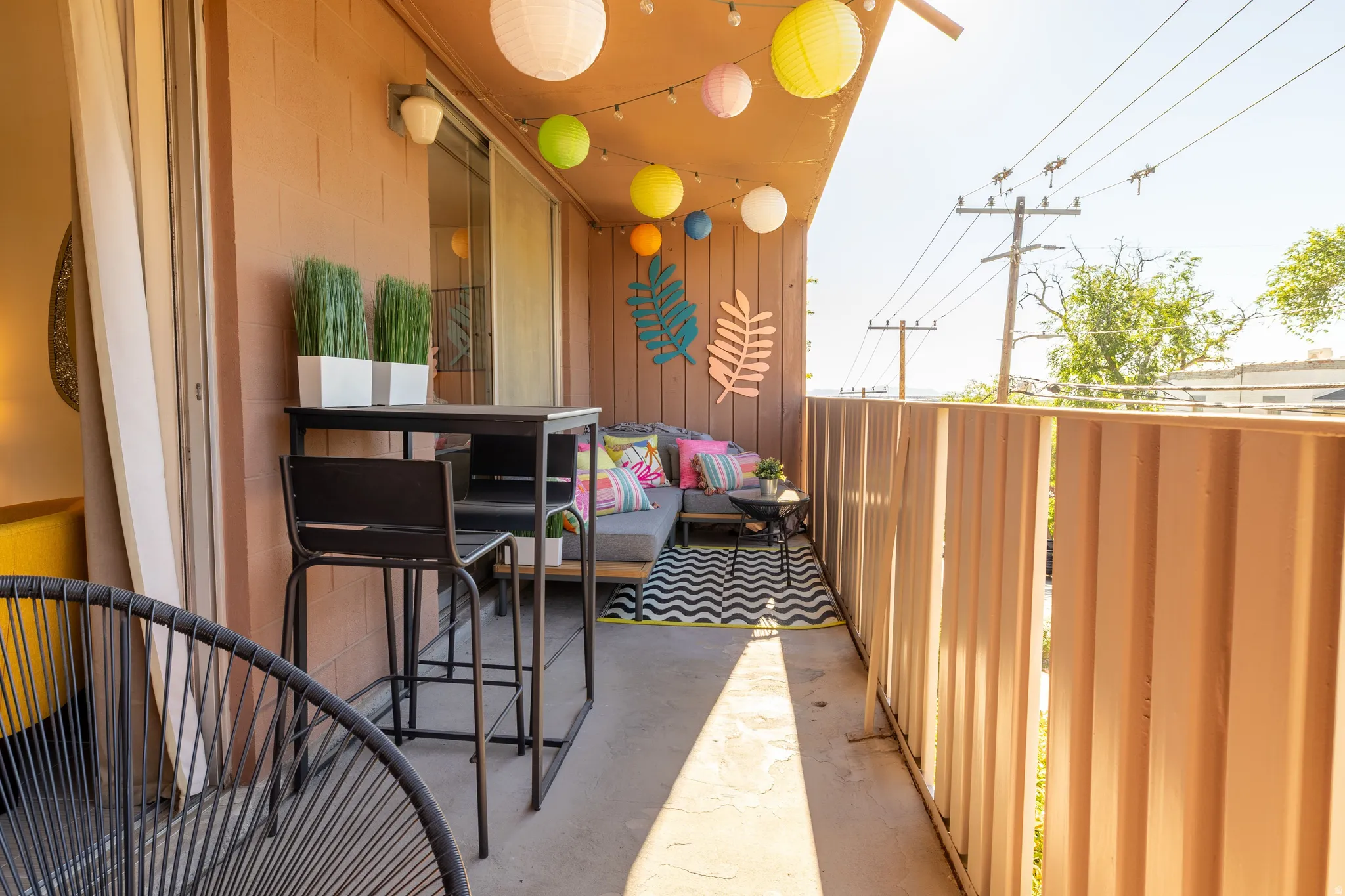 Private outdoor balcony with a sliding glass door and durable concrete flooring