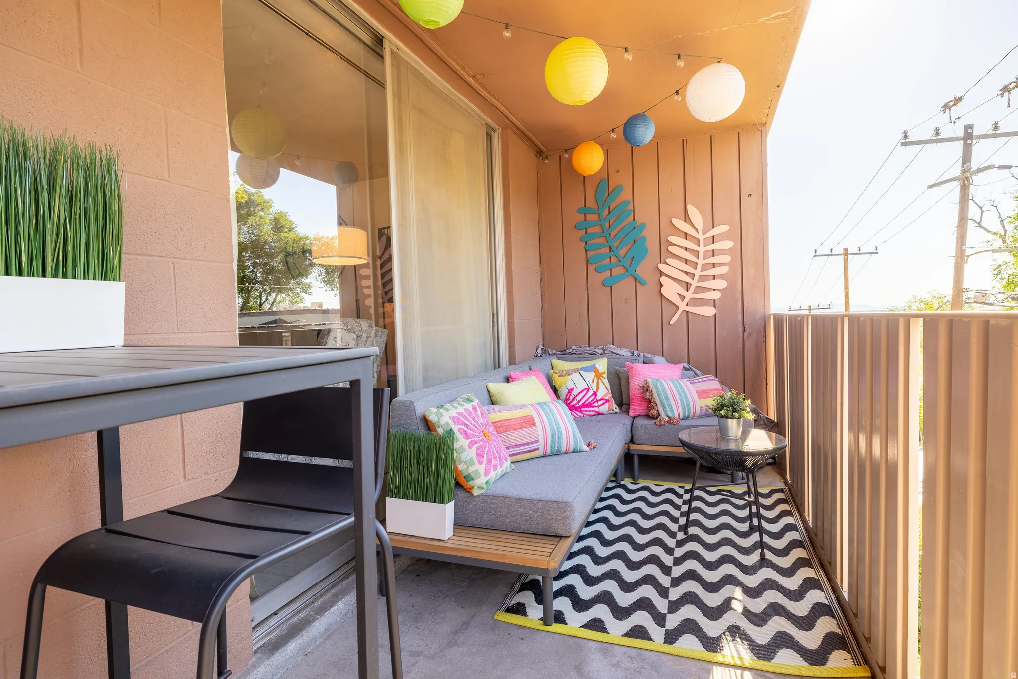 Balcony with wood-paneled walls and a concrete floor