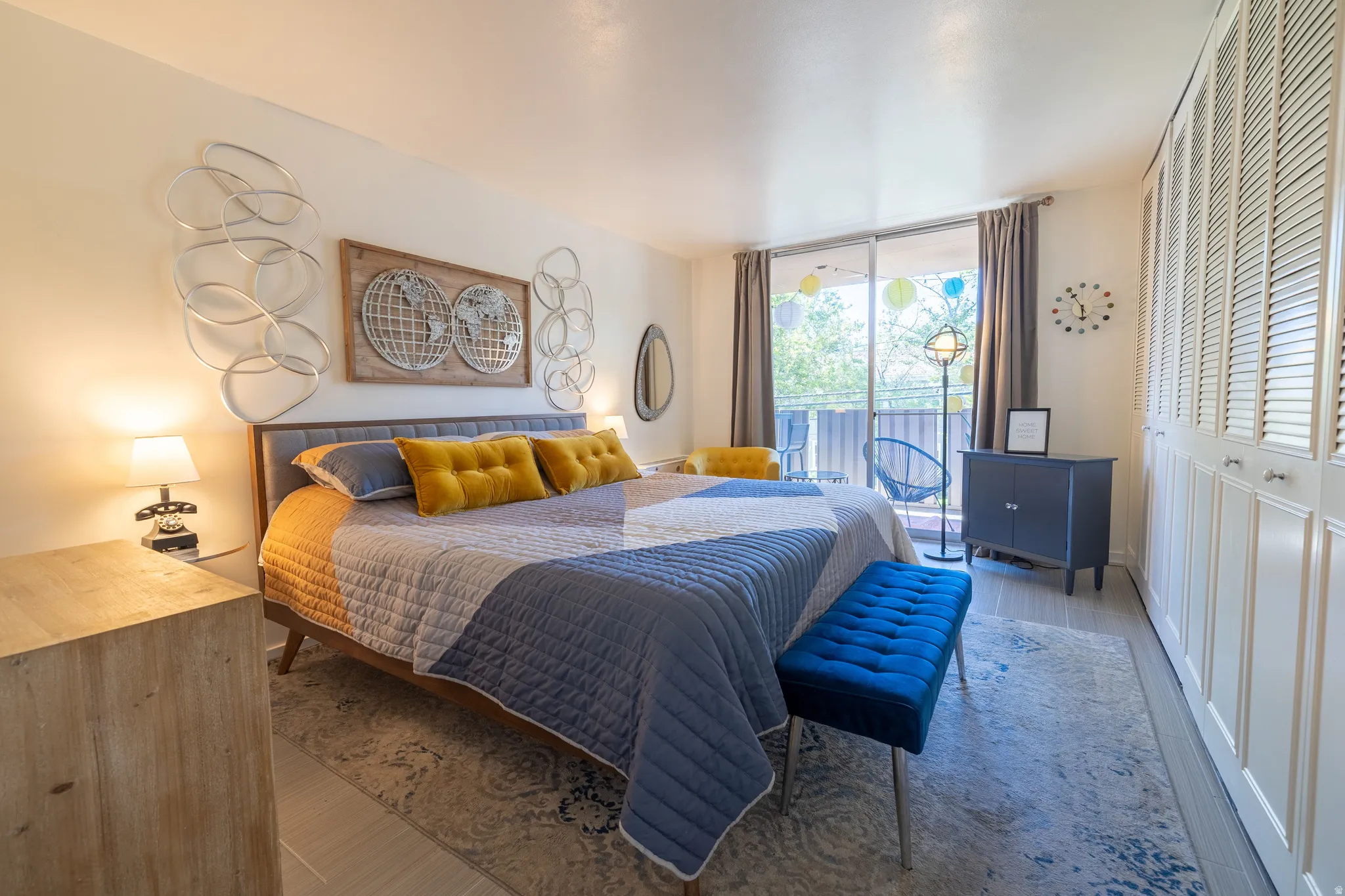 Spacious room featuring a large sliding glass door, a private outdoor area, and extensive built-in louvered cabinetry